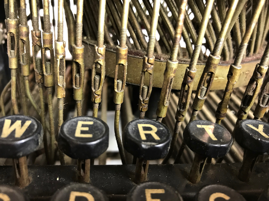 The type levers include small turnbuckles to adjust the keystroke.