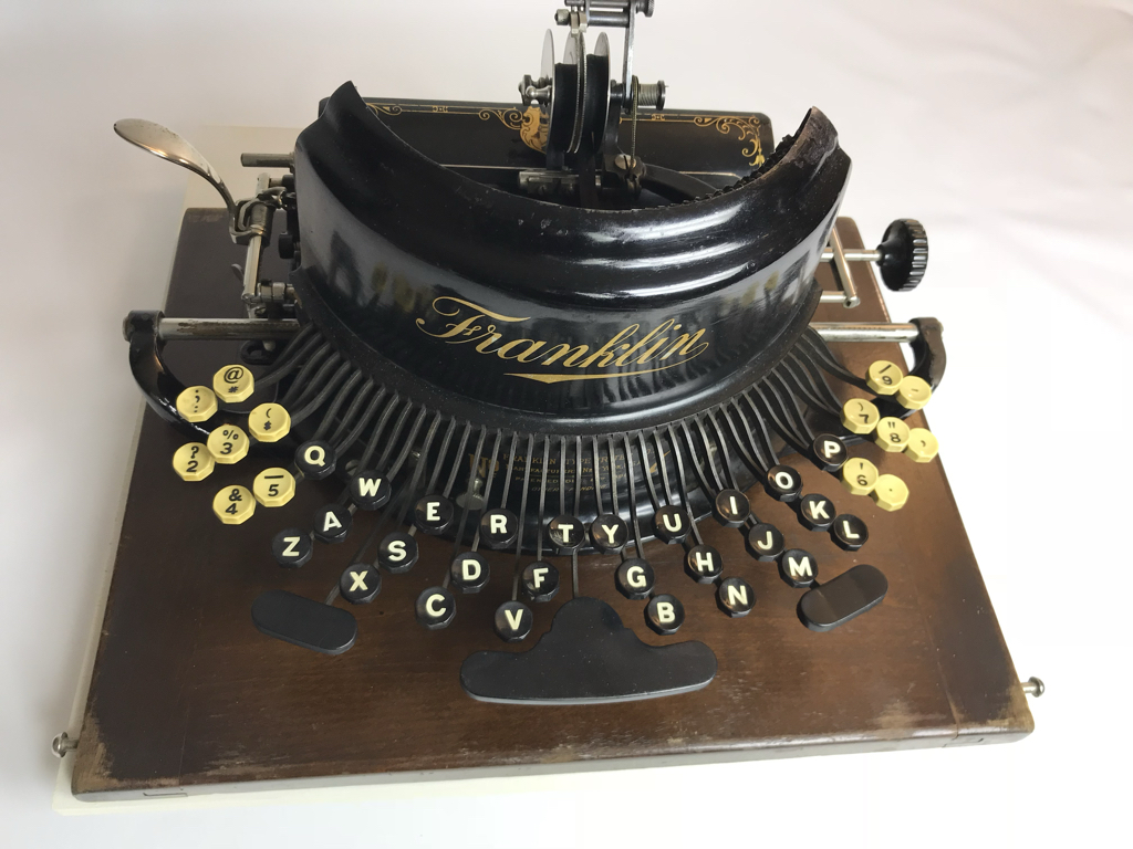 The unusual curved key layout may have been intended to simplify typing for two-finger typists. It was not an ergonomic key layout.