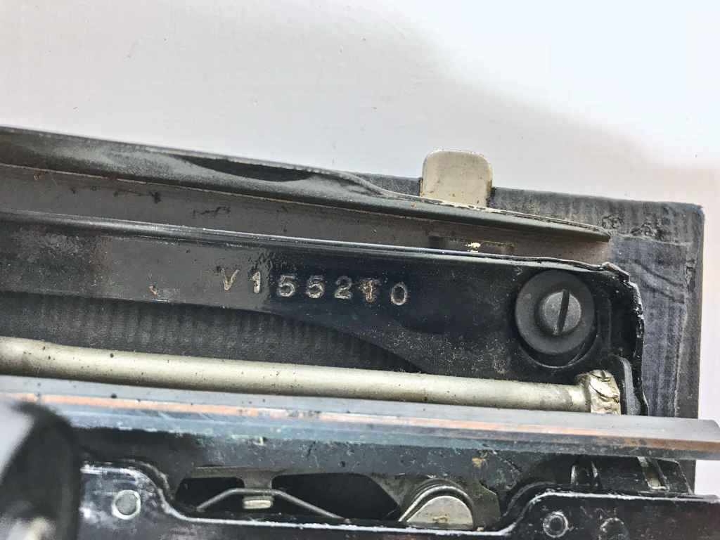 The serial number # V155210 can be seen here. Also visible is one of the screws connecting the frame to the case base.